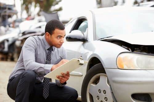 A car insurance adjuster takes notes for a settlement offer in Georgia
