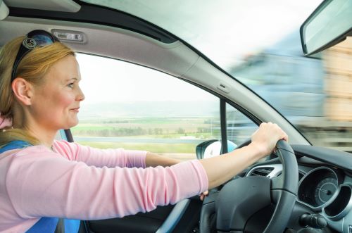 A woman uses defensive driving to stay safe on the road.
