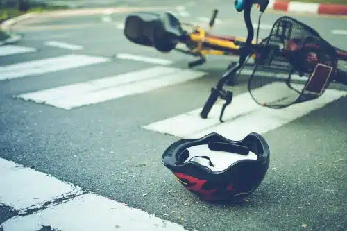 Helmet and bike lying in the road after an accident.