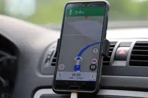 A cell phone is safely out of the driver's hands.