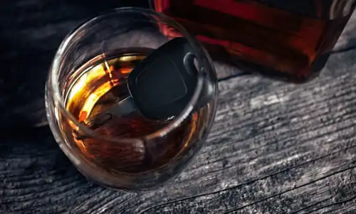 A glass of alcohol and a car key, drunk driving concept.