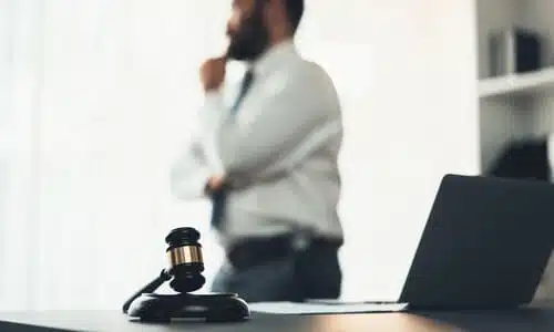 A selective focus shot of a dog bite lawyer in an office contemplating a case.