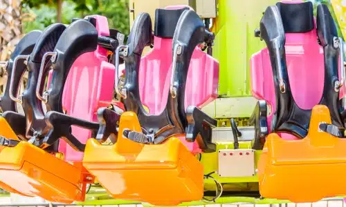 A shot of a theme park ride's seats with safety harnesses.