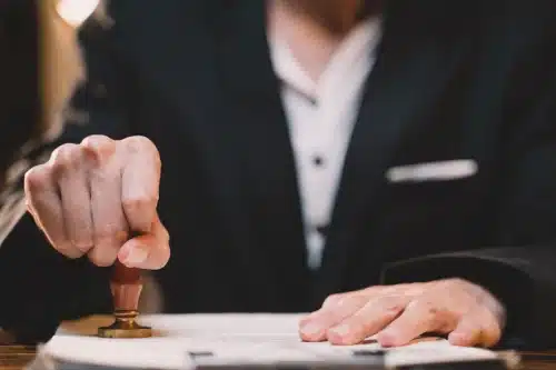 A personal injury lawyer stamping some important documents for a client's case.