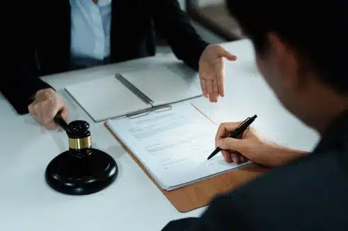 A lawyer assisting a client with documents necessary to make an accident claim.
