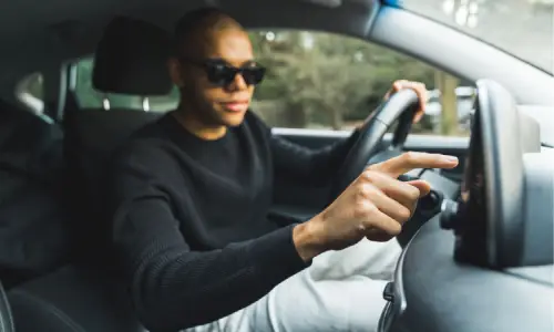 A rideshare driver logging into his application before driving to get a passenger.