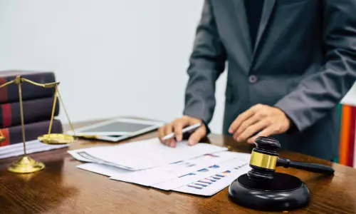 A lawyer looking at documents necessary for a client's personal injury case.