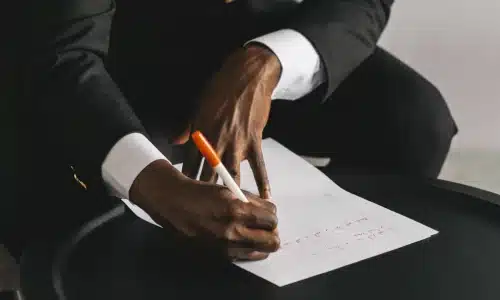 A slip and fall lawyer at a low table and writing a letter on behalf of his client.