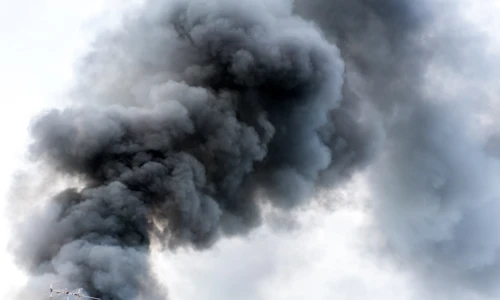 A mass of dark smoke rising into the sky, symbolizing the environmental destruction caused by the BioLab explosion, leading to the BioLab class action lawsuit.