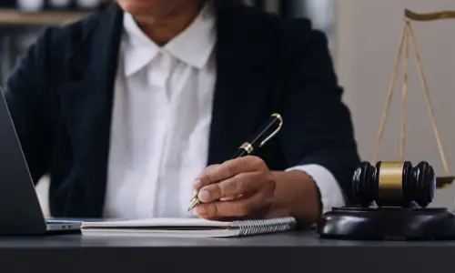 A workers' compensation lawyer at a laptop filling up documents for a client.