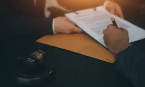 A personal injury lawyer's client filling up documents in preparation for making a claim.