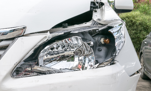 A shattered driver's side headlamp after a hit and run accident by another driver.