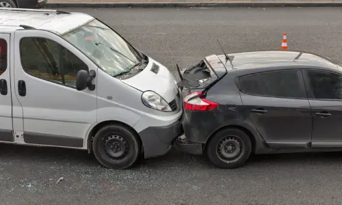 A rear-end collision between a van and a family hatchback.