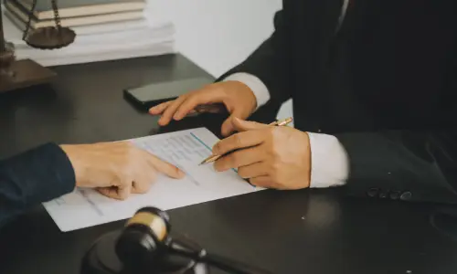A personal injury lawyer assisting a client with forms they need to fill up for their claim.