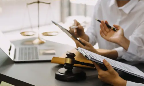Personal injury lawyers at a table discussing strategy and building a case for a client.