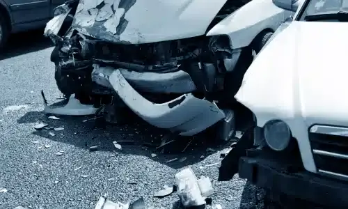 Damaged cars on a road after an uninsured motorist accident.