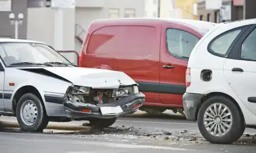 Three vehicles stopped after being involved in an accident on the road.