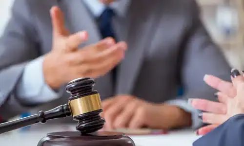 A lawyer explaining workers' compensation to an injured female client.