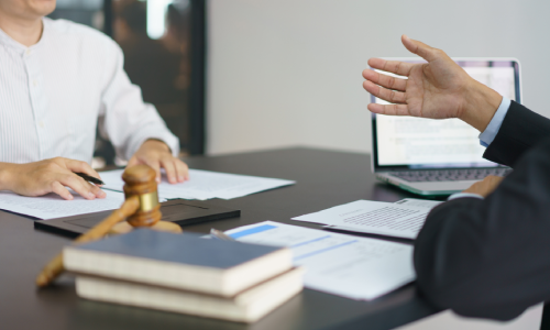 An accident victim consulting with a personal injury lawyer for help with a claim.
