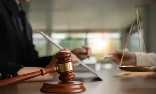 A lawyer presenting documentation for an insurance claim to a client.