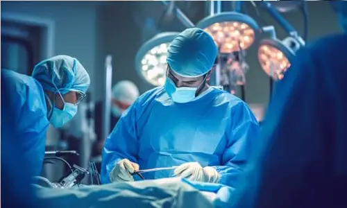 A surgeon and medical team working on a patient in an operating room.