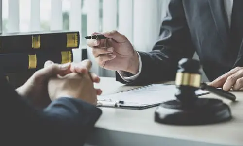 A workers' compensation lawyer advising a client on how to make a workplace injury claim.