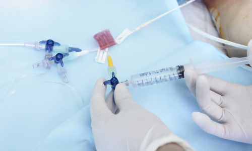 A doctor administering anaesthesia to a patient via a syringe.