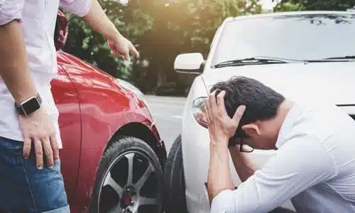 An angry driver yelling at another after a road rage incident led to a crash.