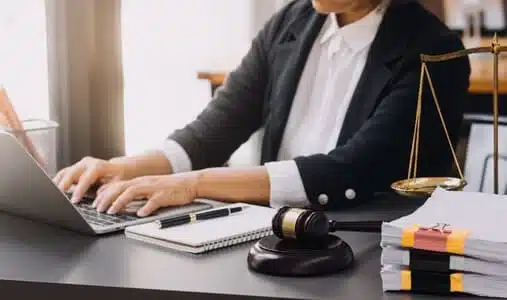A whiplash injury lawyer doing research on her laptop to build a case for her client.