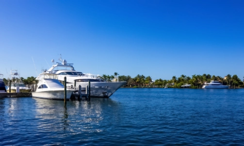 Two boats anchored at the docks on a clear day.