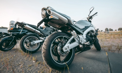 Motorcycles parked next to each other on a platform in a field.