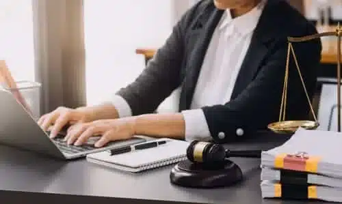 A personal injury lawyer hard at work on a laptop while building his client's case.
