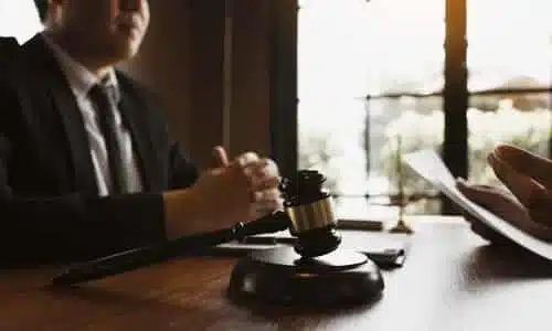 A personal injury lawyer speaking with a client who is holding their insurance policy documents.