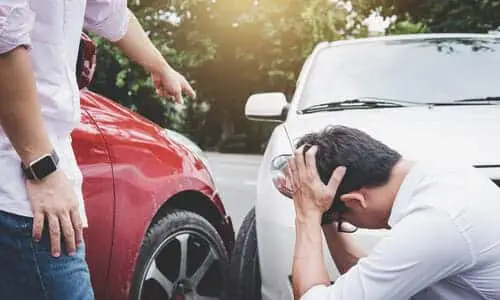 A driver yelling at a drunk driver who caused a collision between their cars.