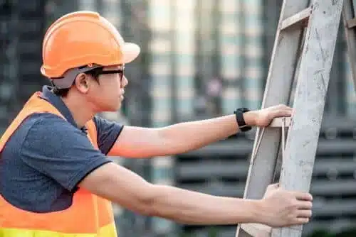 construction worker climbing an ladder
