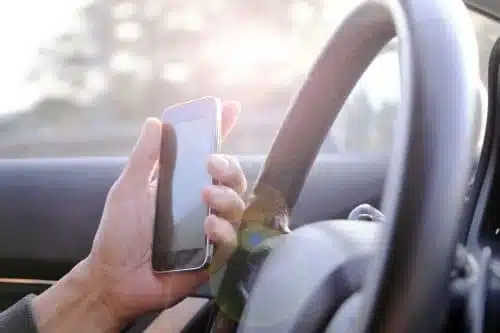 distracted driver using her cell phone