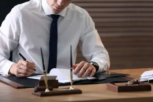 A medical malpractice laywer in Duluth writes a brief at his desk.