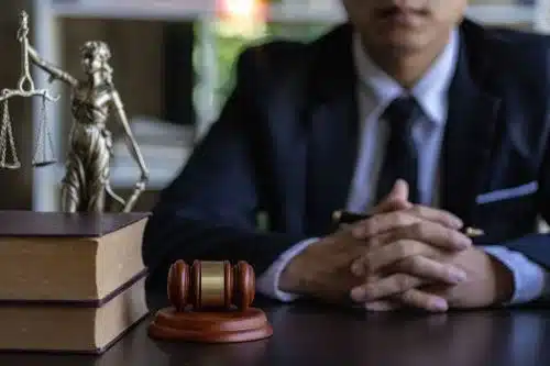 A motorcycle accident lawyer is seated at his desk in his Fulton county law office.