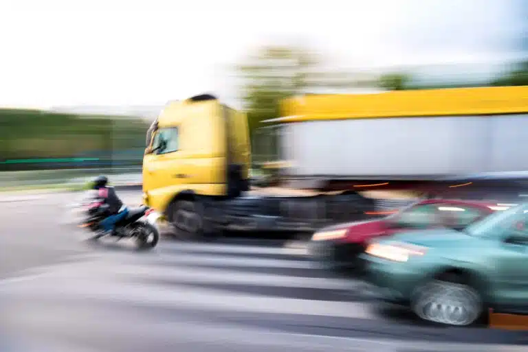 big rig truck almost hitting a motorcycle