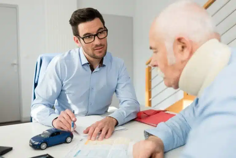 A lawyer meets with a client about the settlement process after a car accident. 