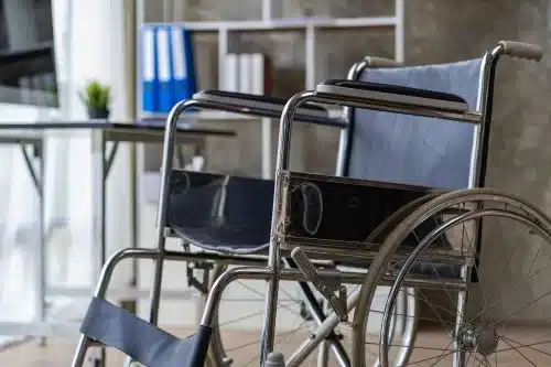 A spinal injury victim's empty wheel chair in a lawyer's office.