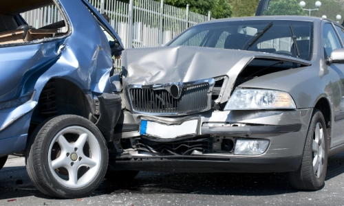 Two cars involved in a serious rear-end collision with significant front and rear damage, representing a car accident scenario.