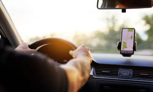 An Uber driver in the late afternoon navigating via GPS to pick up a passenger.