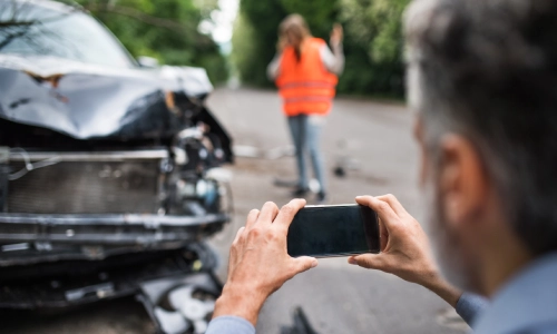 A Gainesville car accident lawyer documenting the accident scene and collecting crucial evidence.