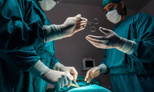 Surgeons in a brightly lit operating room perform a medical procedure, symbolizing the high-stakes environment where medical malpractice can occur.