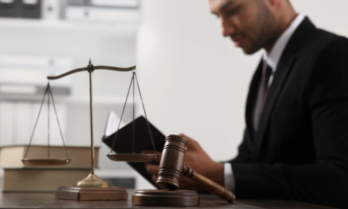 A Gainesville Rideshare Accident Lawyer sitting in a law office while reading documents inside a black binder
