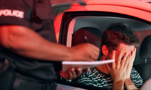 A frustrated drunk driver being stopped by police for suspected intoxicated driving and may need help from a Houston drunk driving accident lawyer.