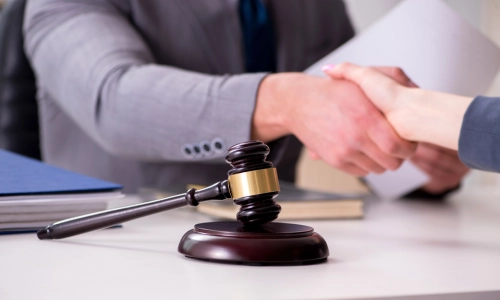 An accident lawyer providing services across Houston is shaking hands with a client after thoroughly discussing the legal details and strategies related to the client’s Lyft accident case.