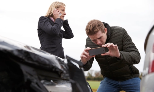 A Nogales uninsured motorist accident lawyer taking a photo of the actual accident scene.