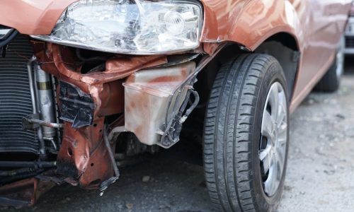 A close up of a broken bumper at the site of a car accident in Riverside